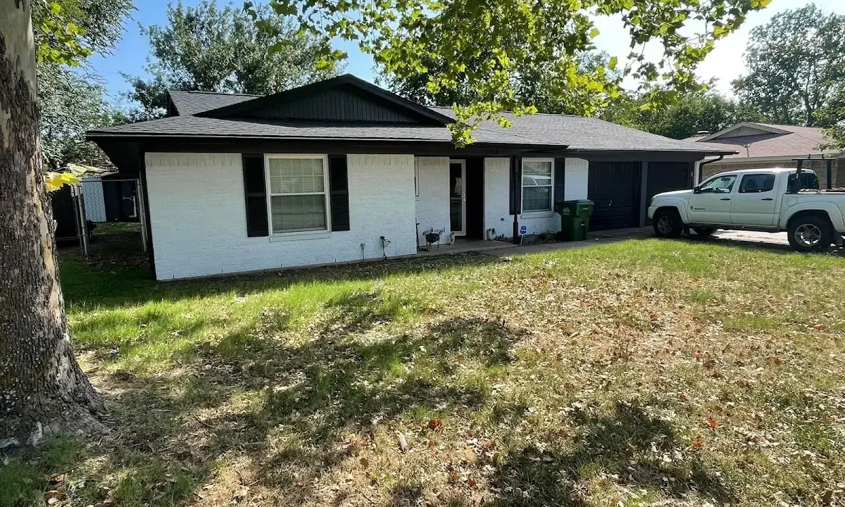 Professional roofing crew working on a residential roof in Aldine
